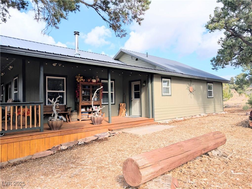 Image 4: Back of property featuring a deck and a metal roof