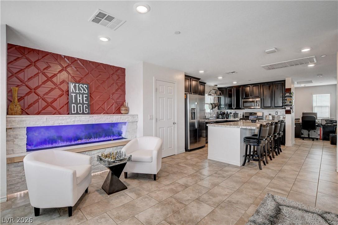 Image 1: A striking red accent wall with an electric firepl