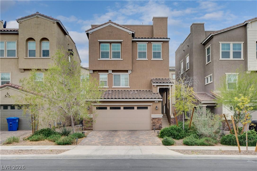 Image 2: A terracotta-hued three-story townhome features a