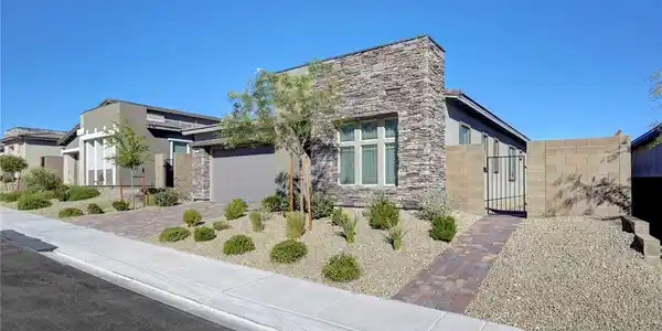 Image 3: A modern facade with striking stone accents and th