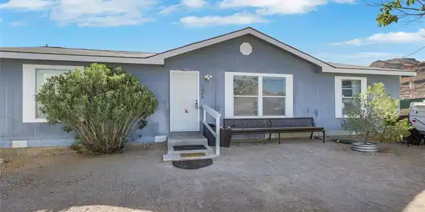 Image 2: A well-maintained single-story residence with a ne