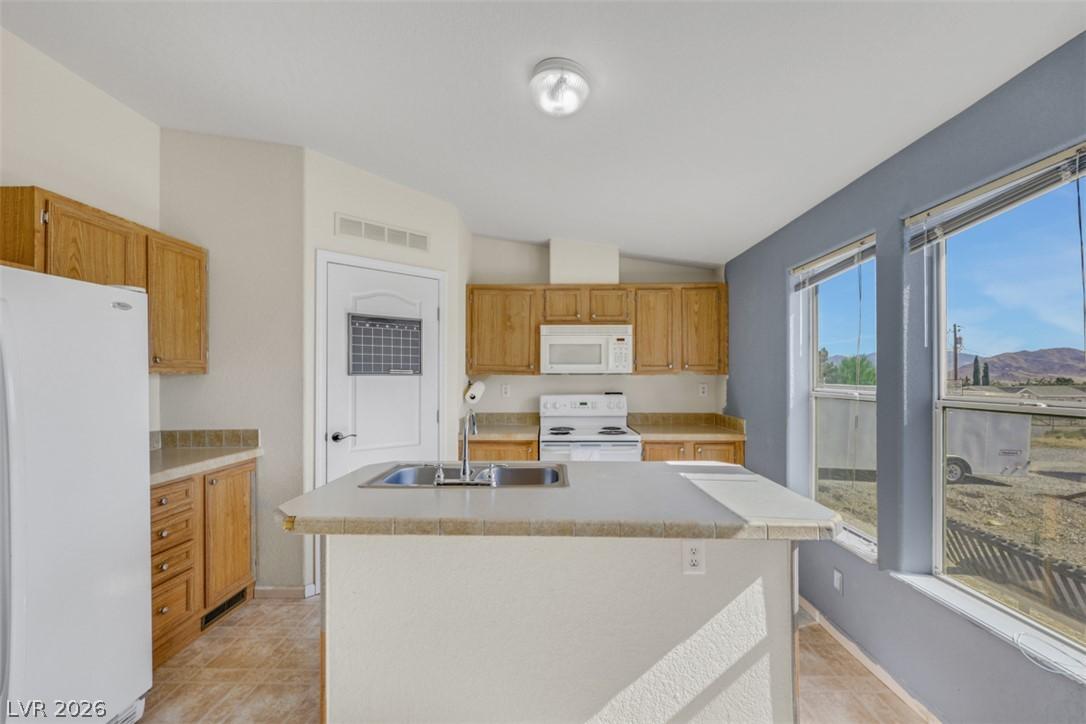 Image 3: A functional kitchen features an island with a dua