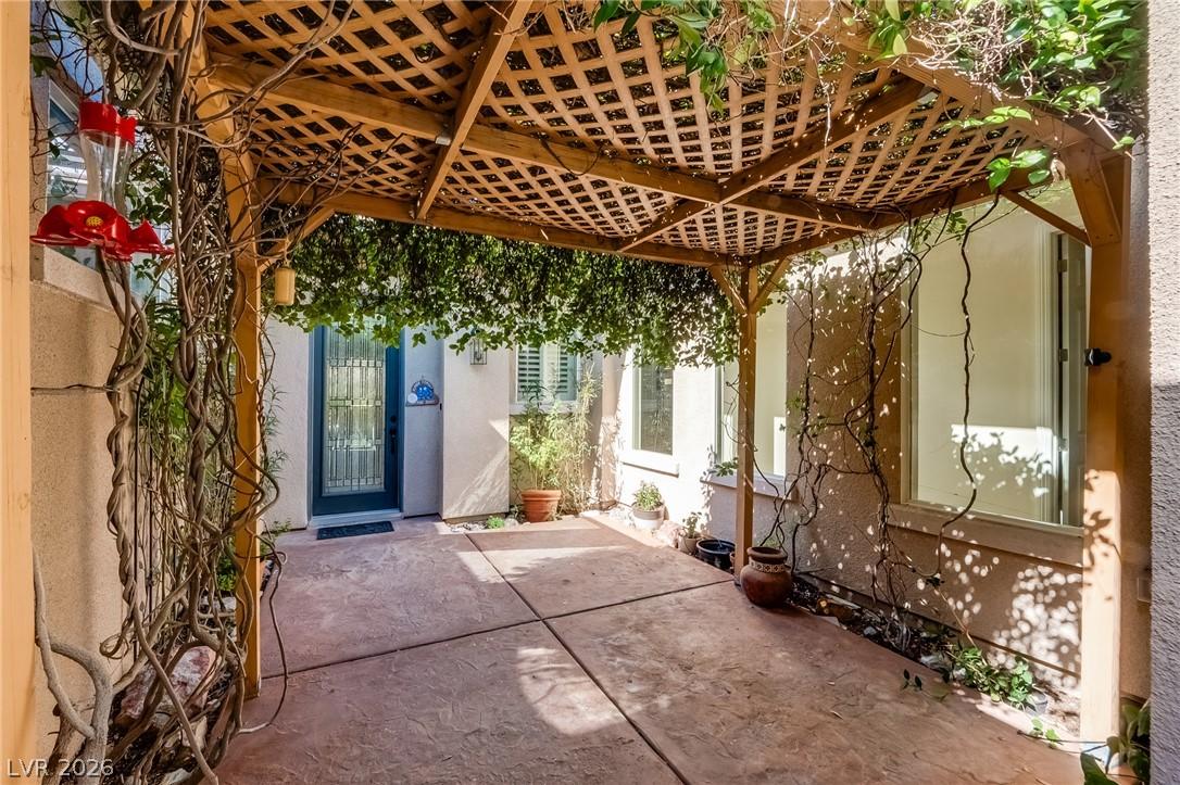 Image 3: A charming covered patio, adorned with climbing vi