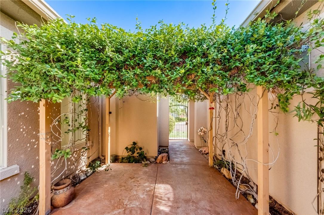 Image 4: A verdant arbor offers a shaded walkway, leading t