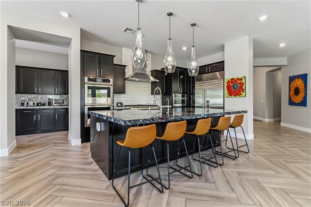 Image 3: This kitchen features a spacious island, sleek app
