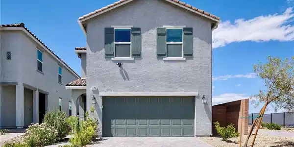 Image 2: Front of Home with 2-Car Garage and Paver Driveway