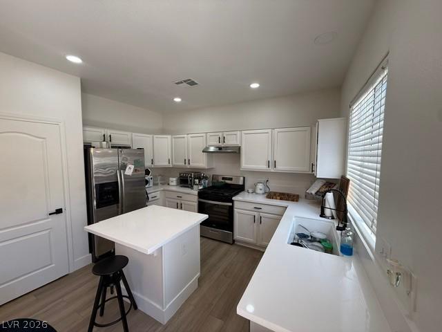 Image 3: White cabinetry and stone countertops elevate this