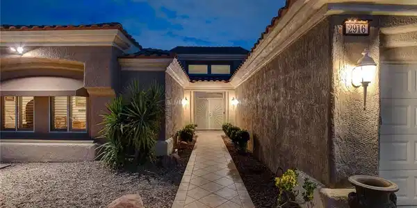 Image 4: Tiled walkway leads to a grand double door entry f