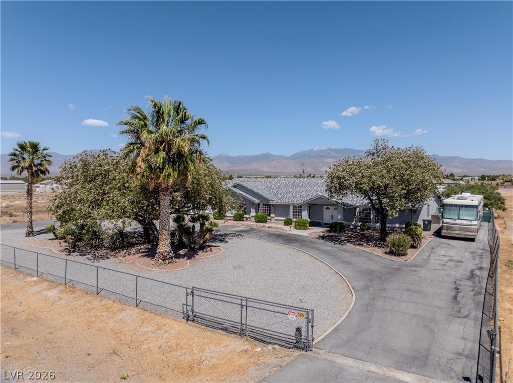 Image 1: This desert oasis features a private driveway lead