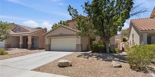 Image 3: An inviting entry with an attached garage and dese