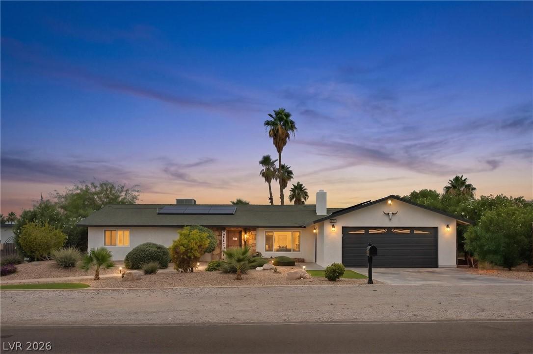 Image 2: An inviting exterior with desert landscaping and s