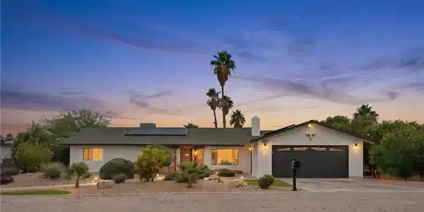 Image 2: An inviting exterior with desert landscaping and s