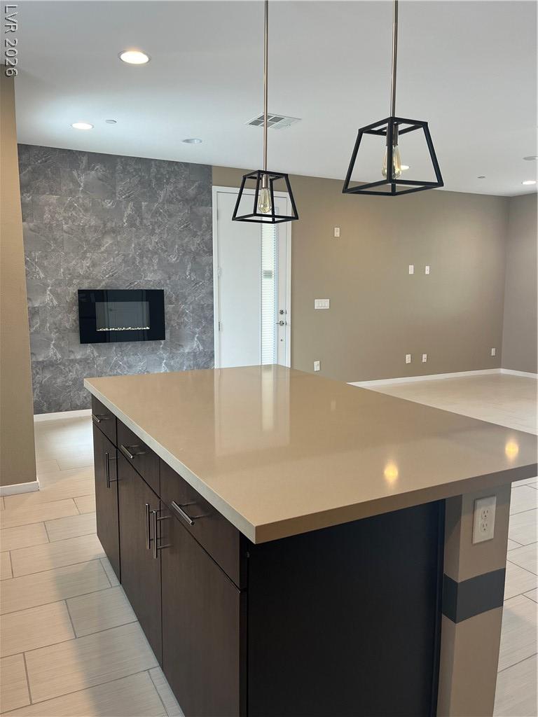 Image 2: A well-lit interior features a sleek kitchen islan