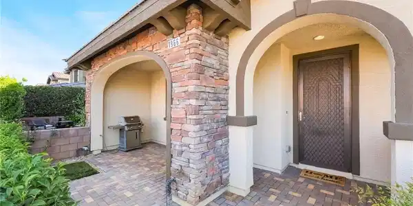 Image 3: Stone accents and an inviting arched entry create
