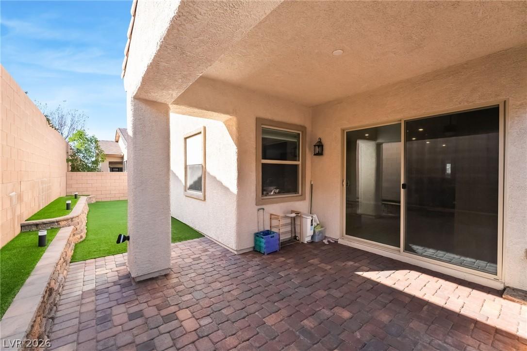 Image 3: Fenced backyard with a patio