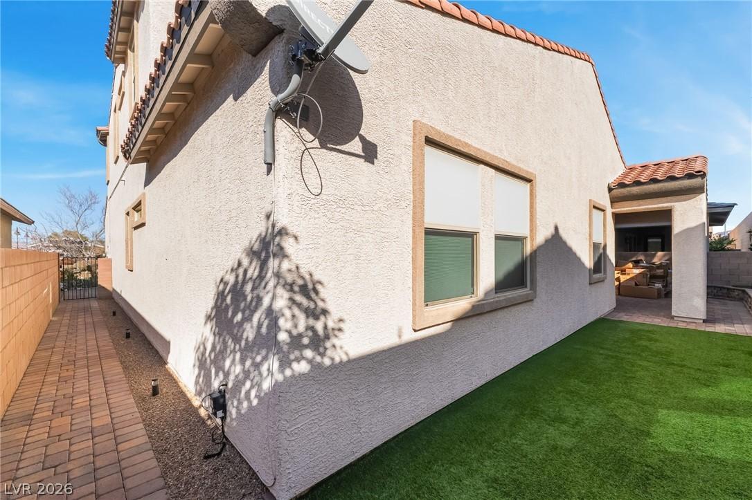 Image 4: View of side of property featuring a tile roof, a