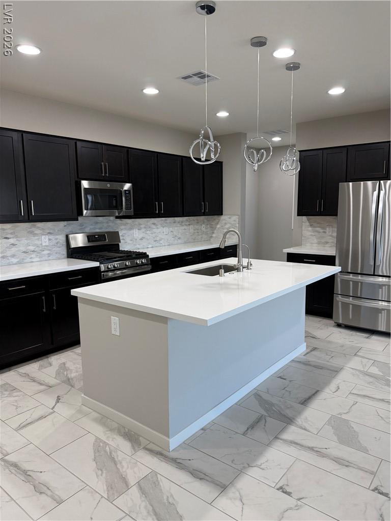 Image 4: A contemporary kitchen features dark cabinetry, st