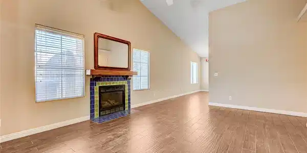 Image 3: Fireplace with colorful tile accents anchors this
