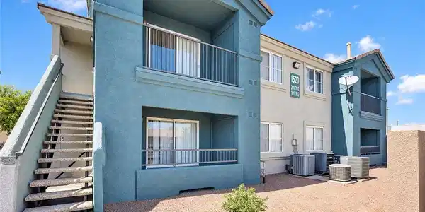 Image 2: Stucco exteriors and covered balconies define the