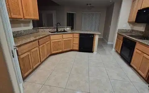 Image 4: A well-appointed culinary space featuring ample ca