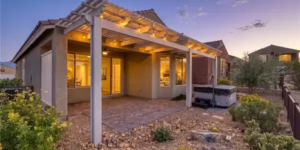 Image 3: A spacious backyard features a covered patio with