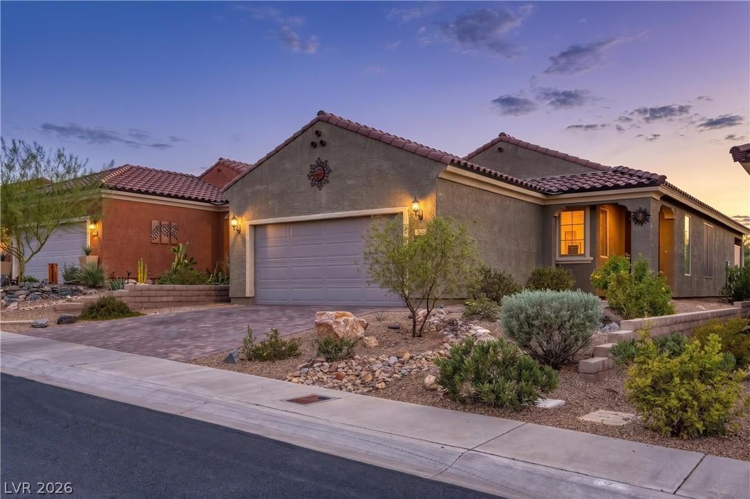 Image 4: A well-maintained stucco home with a tile roof and
