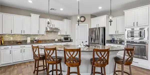 Image 2: Rich wood floors complement pristine cabinetry and