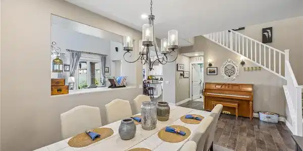 Image 4: An open dining area features smooth tile floors, n