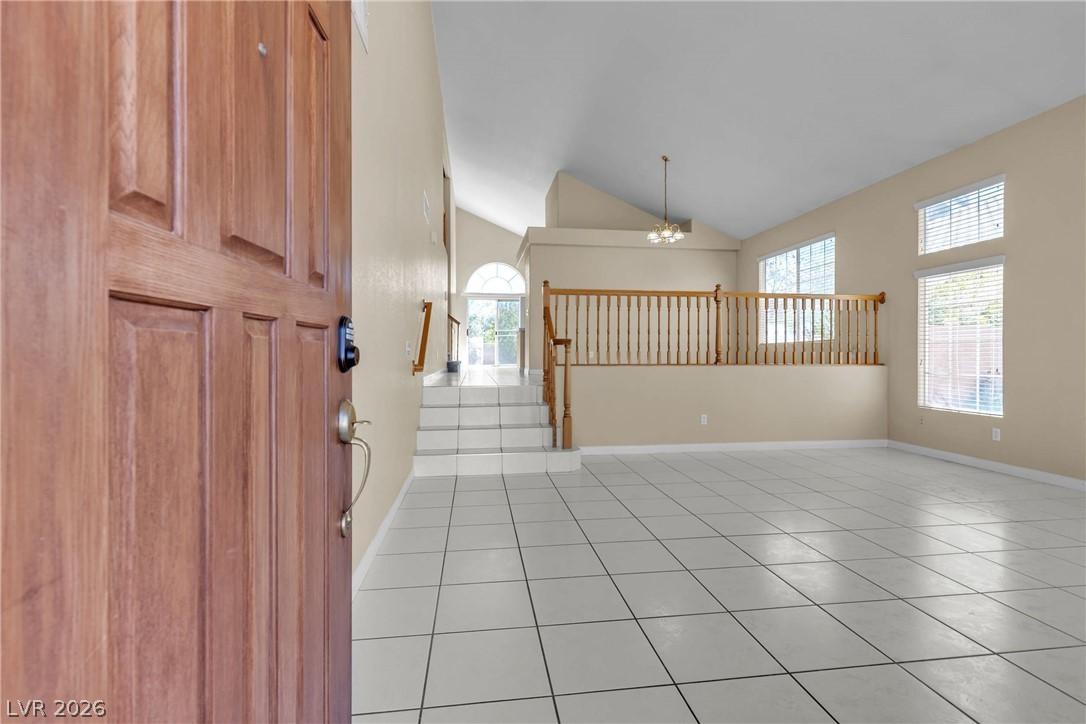 Image 4: A welcoming entry unveils high ceilings and abunda