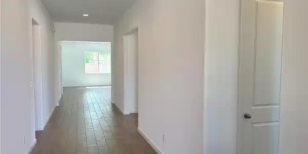 Image 3: Corridor featuring dark wood-style floors and rece