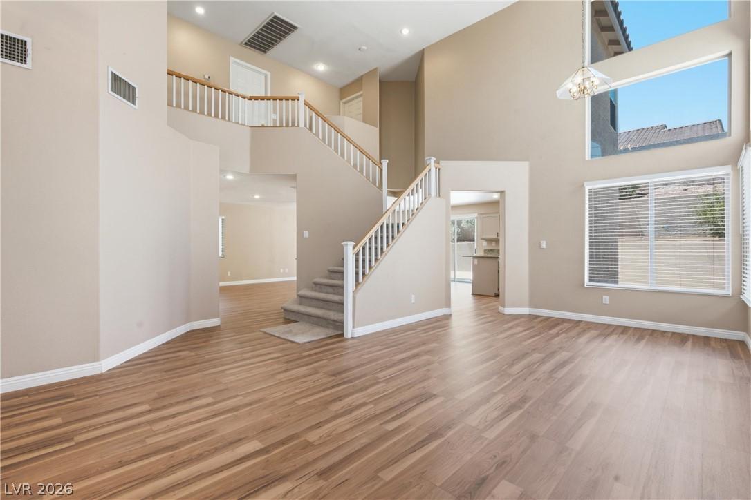 Image 4: A spacious entry showcases a grand staircase and a