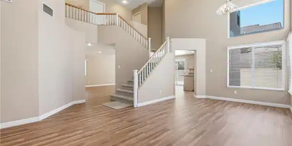 Image 4: A spacious entry showcases a grand staircase and a