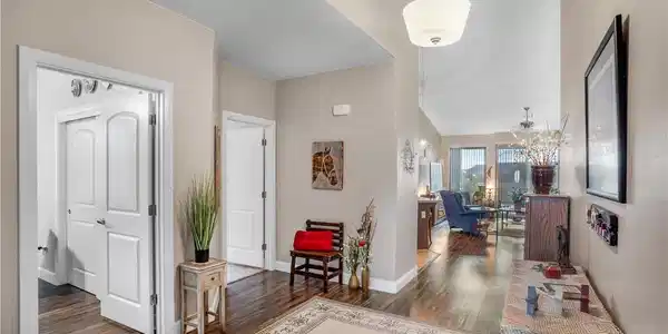 Image 2: Gleaming hardwood floors and a soaring ceiling wel
