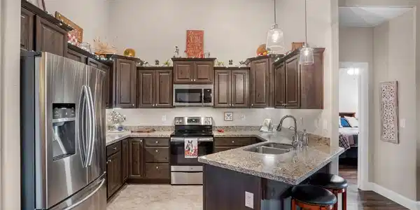 Image 3: Vaulted ceilings soar over rich wooden cabinetry a