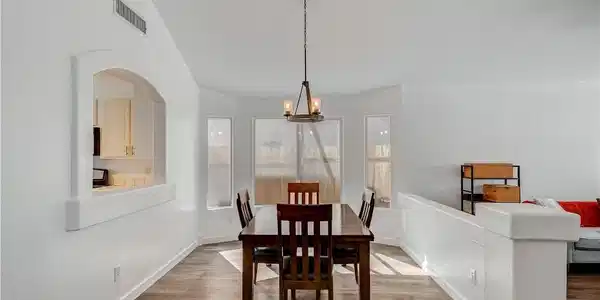 Image 2: Vaulted ceilings and wood-style flooring elevate t