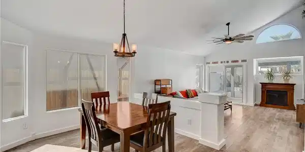 Image 3: A spacious open-concept interior features wood-loo