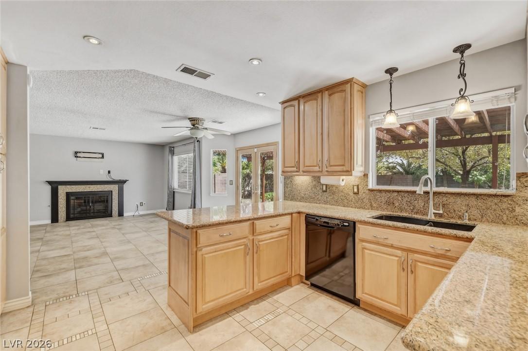 Image 3: A vibrant kitchen with granite counters opens to a