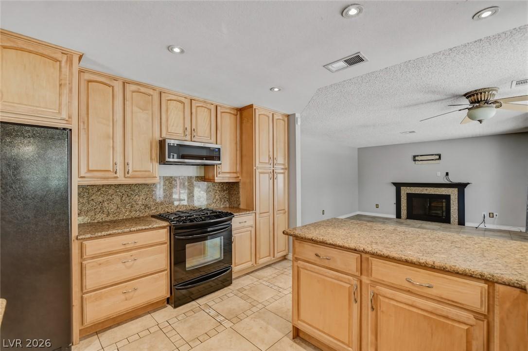 Image 4: A well-appointed kitchen flows seamlessly into the