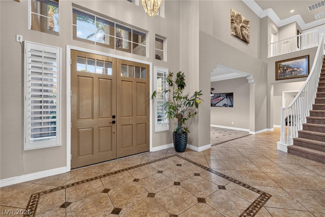 Image 4: Grand double doors open to a soaring entryway with