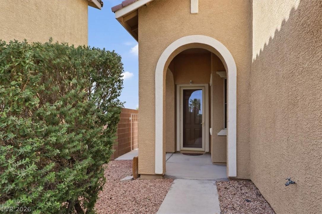 Image 2: An inviting arched entryway leads to a welcoming f