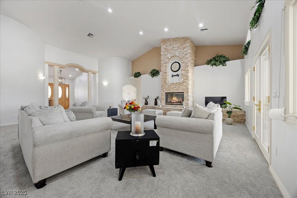 Image 4: Living area featuring light carpet, a fireplace, l