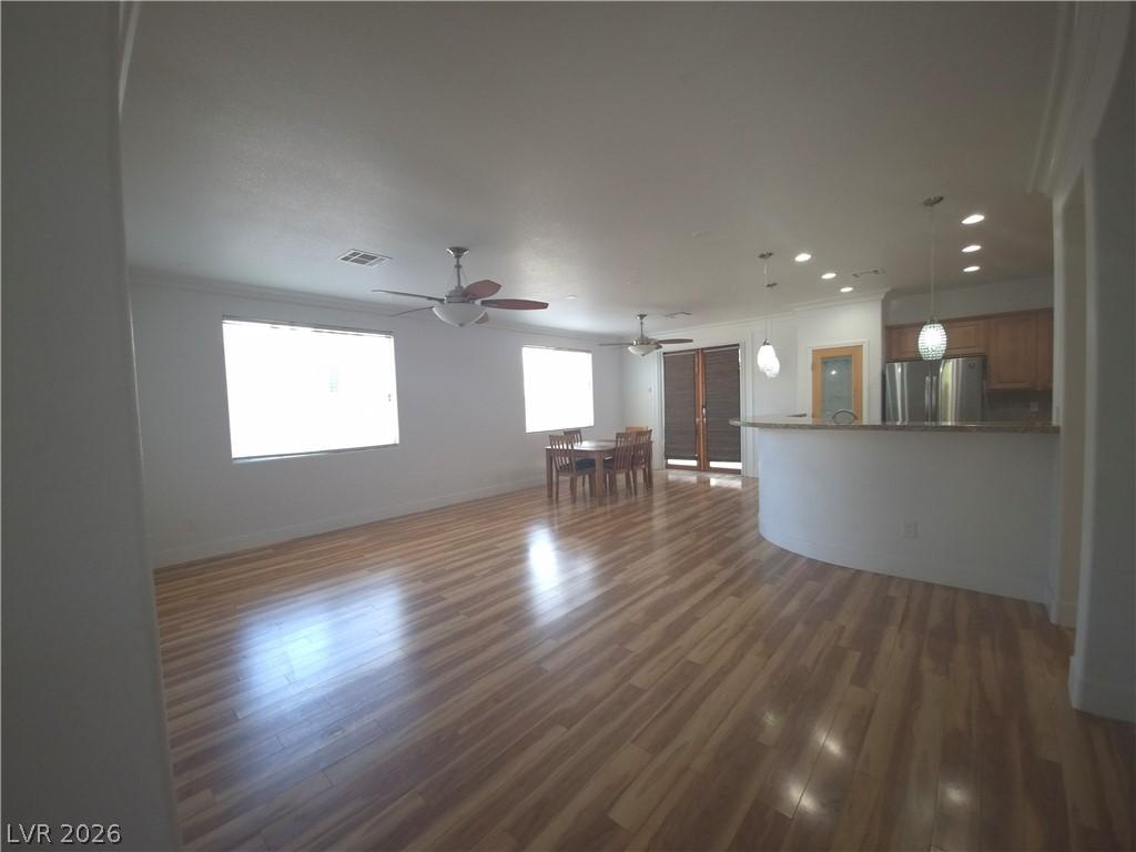 Image 4: A well-lit interior showcasing rich wood flooring