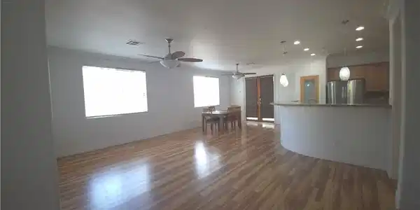 Image 4: A well-lit interior showcasing rich wood flooring
