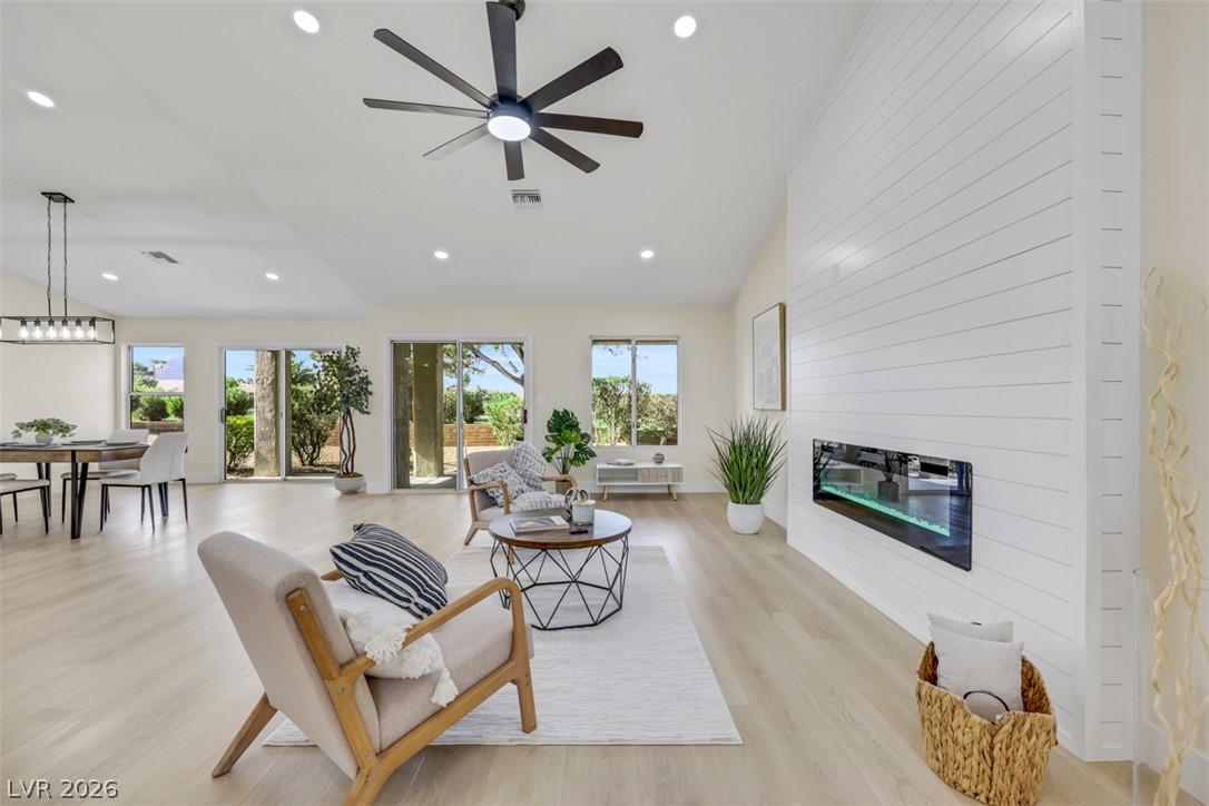 Image 1: A spacious living area boasts hardwood flooring, v