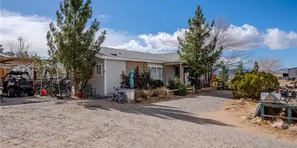 Image 2: This charming residence is nestled among mature tr