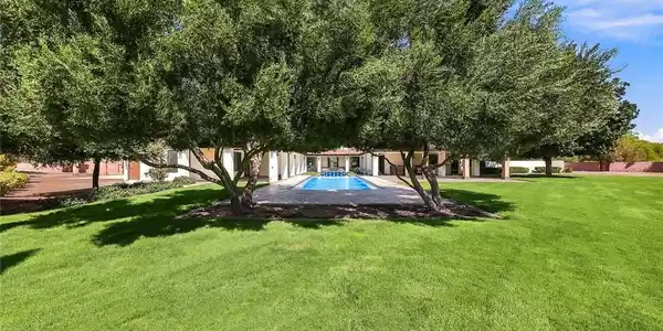 Image 2: Your inviting backyard oasis features a fully remo