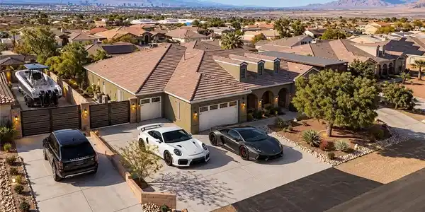 Image 2: An inviting exterior with a wide driveway and meti