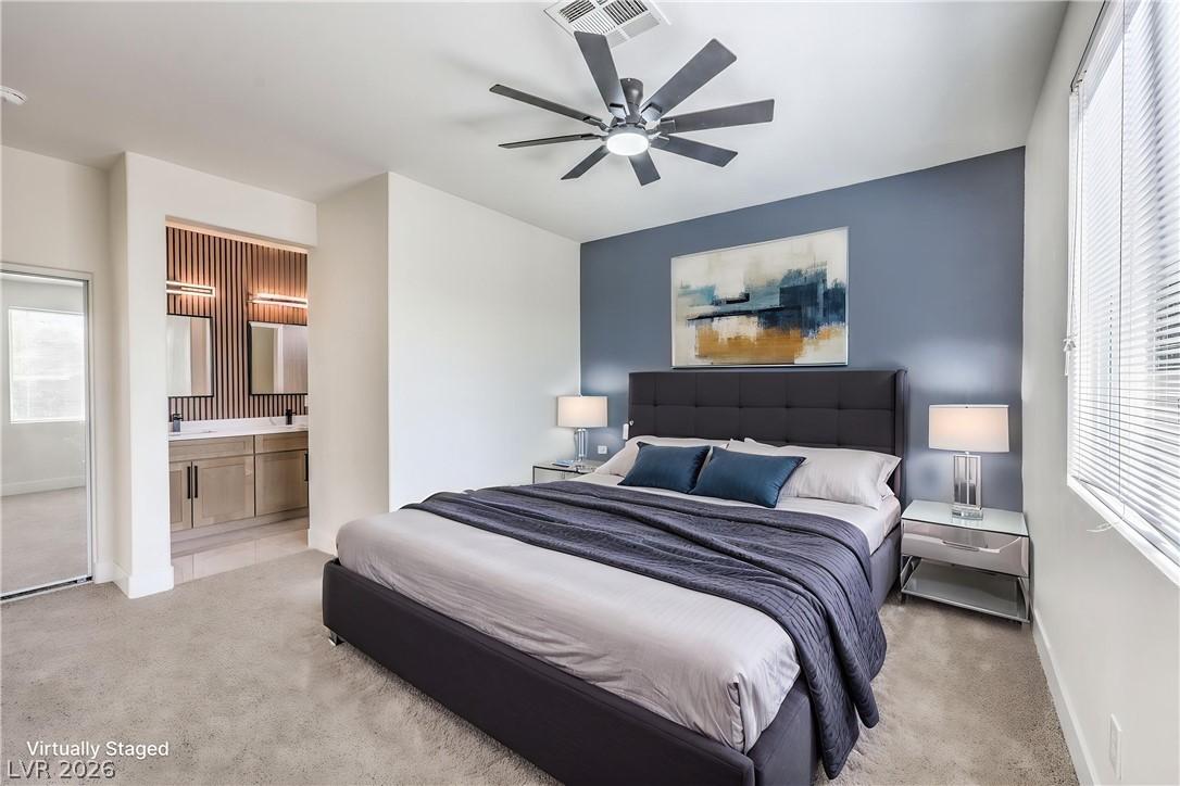Image 4: A well-appointed primary bedroom retreat featuring
