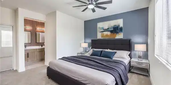 Image 4: A well-appointed primary bedroom retreat featuring