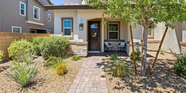 Image 2: This home features a welcoming covered entry and a